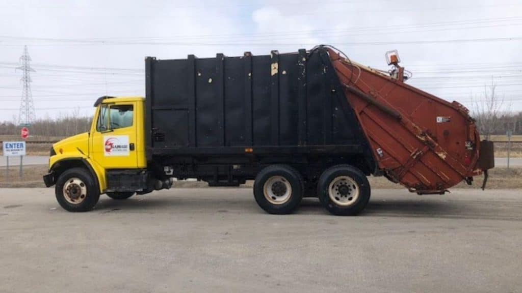Construction bin rental site in Winnipeg with large walk-in disposal bins for residential and commercial projects